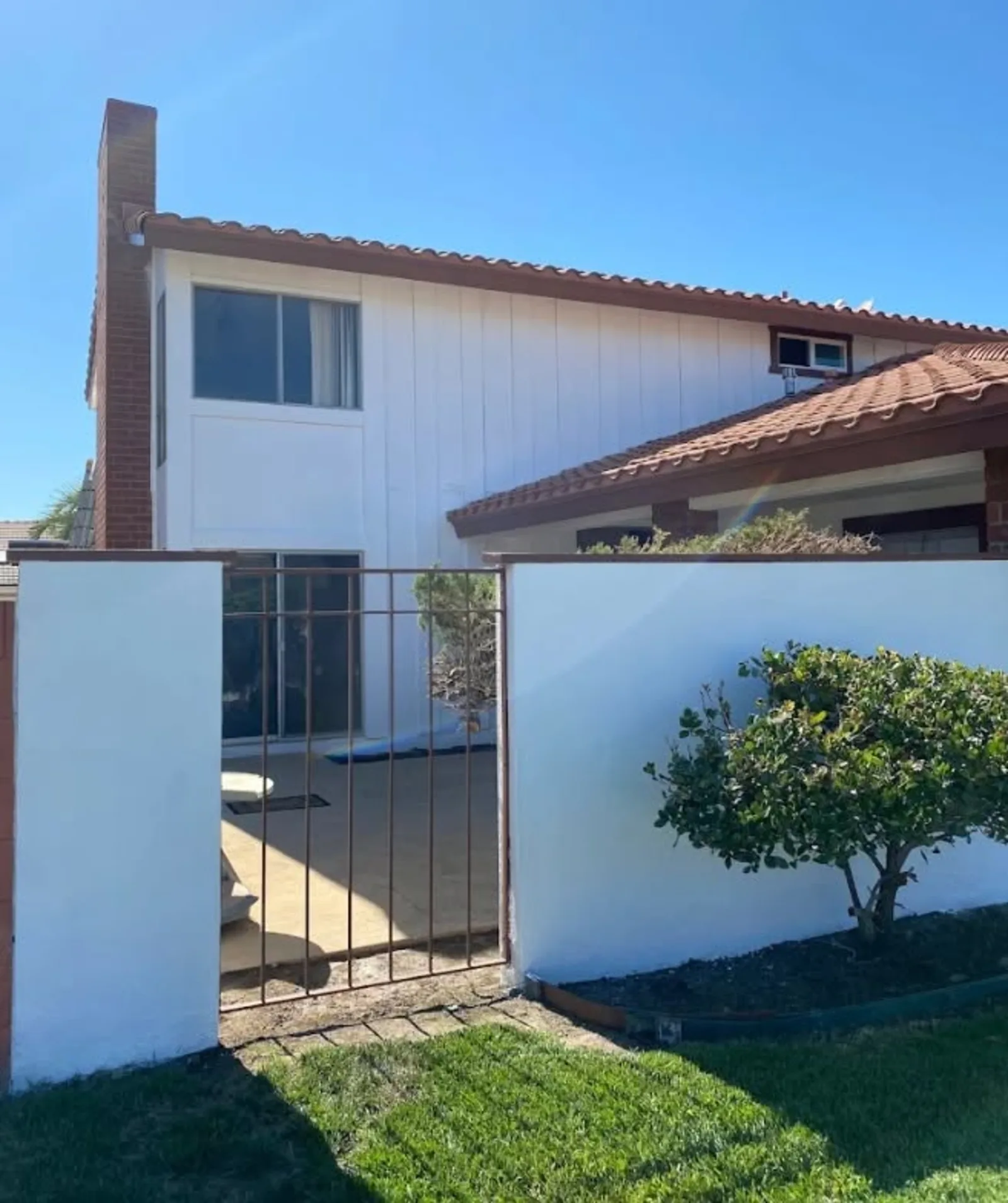 White Spanish-style home with tile roof and clean repaint